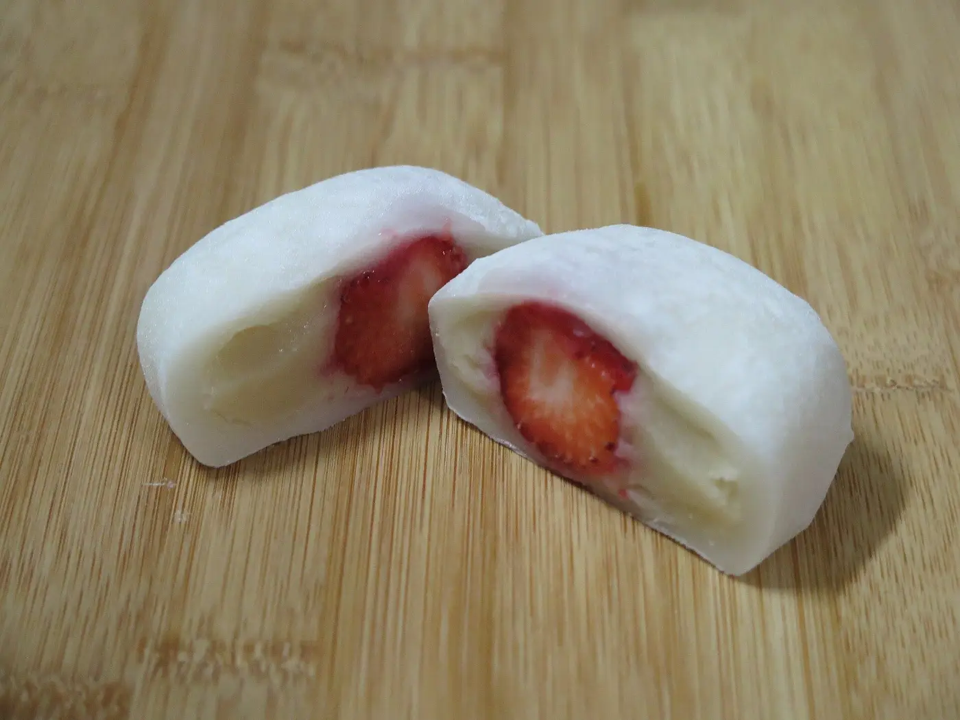A strawberry daifuku cut in half