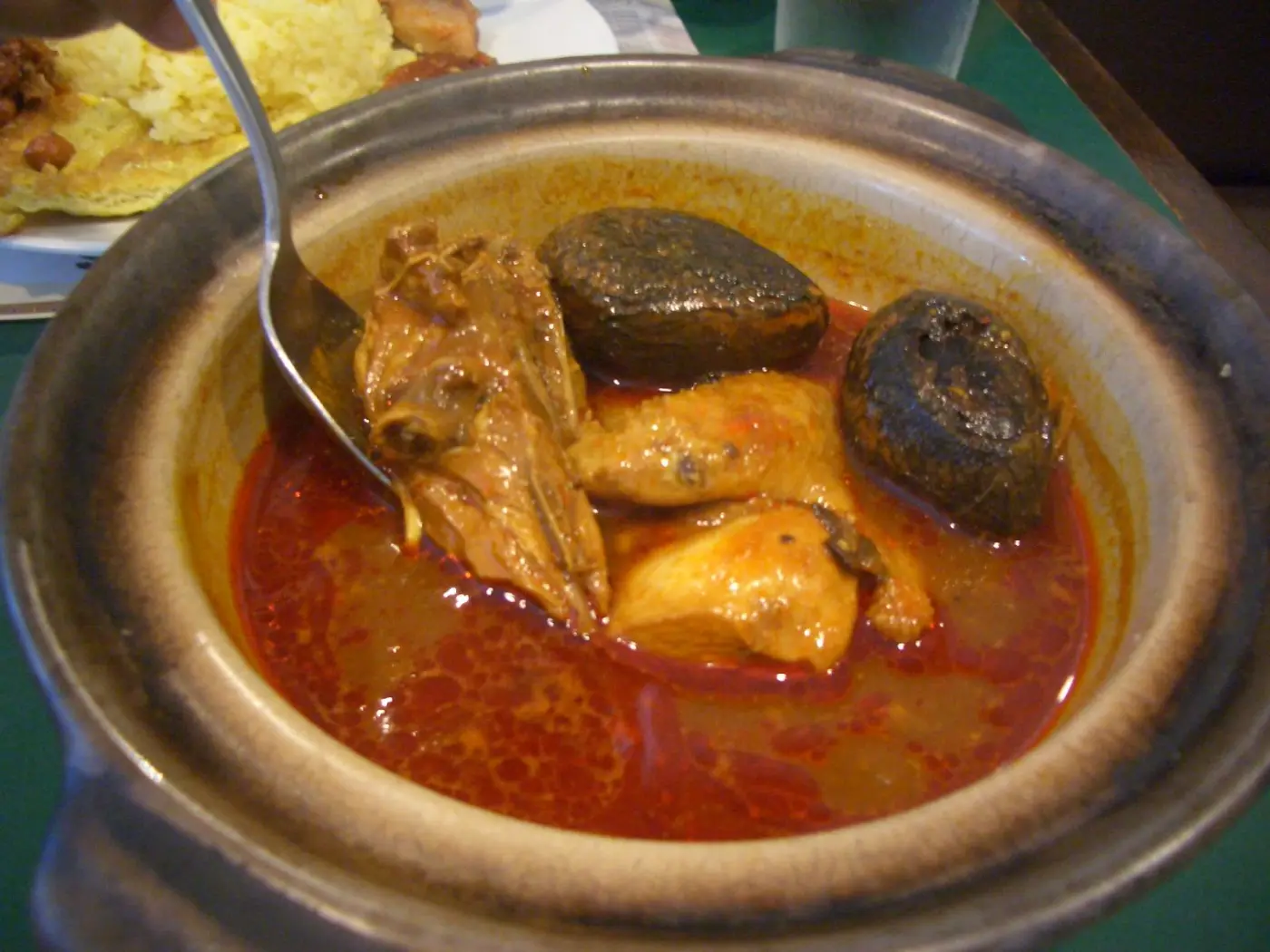 Ayam buah keluak, chicken and black nuts in a dark tamarind gravy